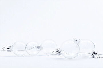 A group of clear glass ornaments are sitting on a white background