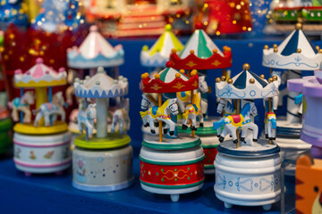 Christmas market in Europe. Bright wooden carousel toys warm the heart with memories of a happy childhood. Basel, Switzerland, 2025.