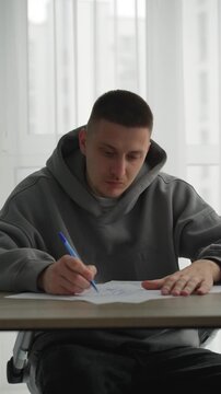 Writing a script at a desk in an office.
A man writes with a pen on a white sheet of paper.
A copy editor writes with a pen in an office.
A man writes a text on paper.
Text, script, documents, editor,