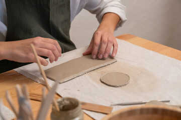 Hands crafting clay slab for ceramic pottery