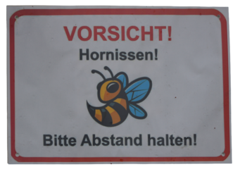 a warning sign with a cute cartoon bee and german text about hornets and keeping distance
