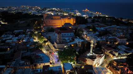Naklejka premium Aerial drone night shot of iconic Palace of the Grand Master in old town of Rhodes island, Dodecanese, Greece