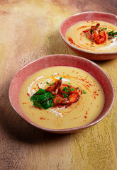 pumpkin cream soup with shrimp, herbs and spices, homemade, no people,
