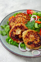 fried chicken cutlets, minced chicken, with vegetables, on gray , with vegetable salad, top view, homemade, no people,