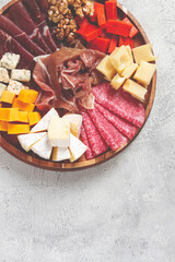assortment of cheese meat cuts, on a plate, top view, no people,