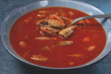 French shrimp bisque soup, in a plate, on a blue background, close-up, no people,
