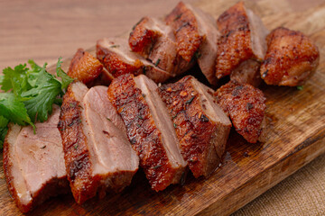 Roast duck breast, sliced, on a wooden chopping board,close-up, no people,