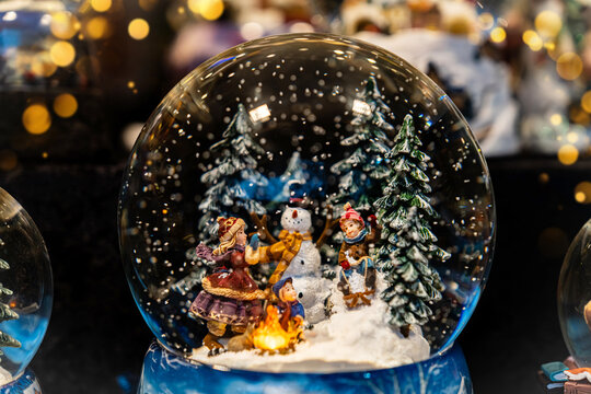 A Christmas snow globe. Christmas market in Europe. The showcase of the store of Christmas and New Year's toys. Winter holidays. Gifts for your loved are here. The Christmas spirit. 2025 