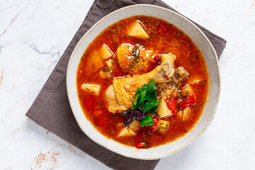 Souzi soup. Georgian dish, meat with oats, tomato sauce and herbs,