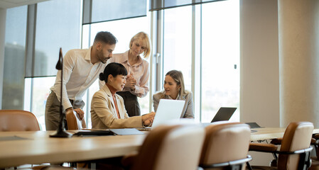 Team members collaborating in a modern office space during a business meeting