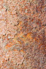 Rusty metal plate front view with rust flakes that are breaking away