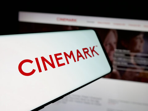 Stuttgart, Germany - 11-18-2025: Smartphone with logo of movie theatre company Cinemark Holdings Inc. on screen in front of website. Focus on center-left of phone display.