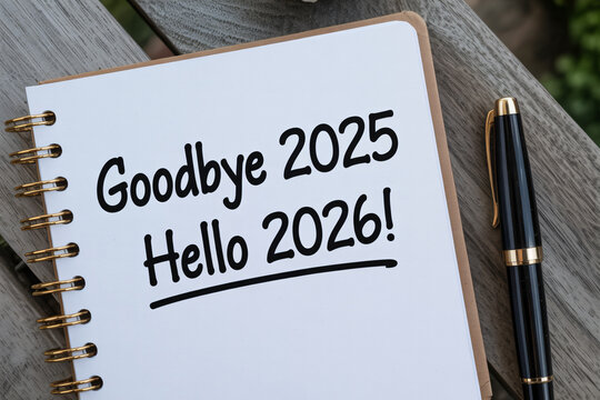 Goodbye 2025 hello 2026 new year goals resolutions planning future notebook pen writing message celebration welcome change opportunity.