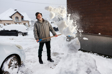 Man is removing snow after the snowfall.