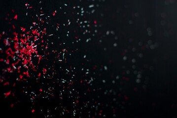 A powerful burst of deep red glitter particles radiating outward with fiery intensity and passionate energy. This striking glitter effect conveys drama and power, perfect for action graphics, 