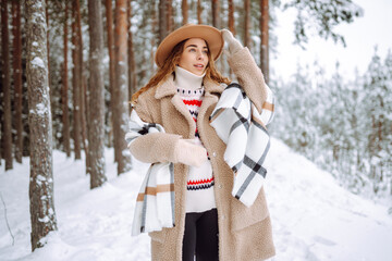 A cheerful woman stands on snowy path, wearing warm clothing. A hiker in a hat enjoys a snowy day...