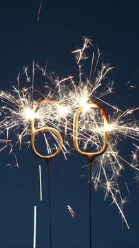 60 years anniversary celebration festive footage made with bengal fires in the form of number Sixty. Vertical footage.