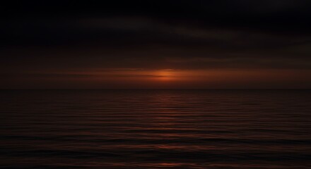 Naklejka premium Calm ocean reflecting the sunset colors of the horizon and sky