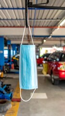 Hanging Face Mask in Auto Repair Shop - Safety and Protection.