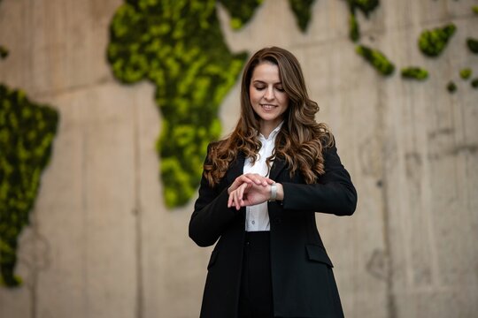 Businesswoman checking smartwatch for global business updates