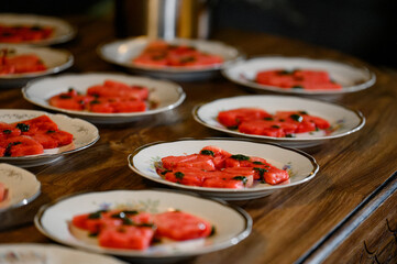 Summer watermelon salad with feta cheese, black olives and herbs
