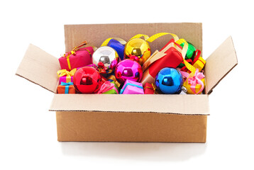 Box filled with colorful Christmas ornaments and gift boxes.