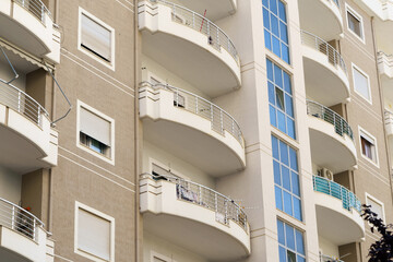 Modern gray apartment building with flat walls and subtle design details in Mediterranean style. Great for real estate listings, holiday rentals, city apartments, and Albanian coastal property markets