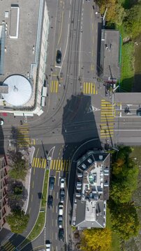 sunny day zurich city center traffic street riverside train station aerial topdown panorama 4k vertical timelapse switzerland