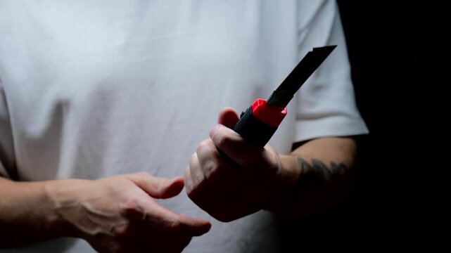 Retractable utility knife.
Universal paper cutter.
Retractable blade cutter on a black background.