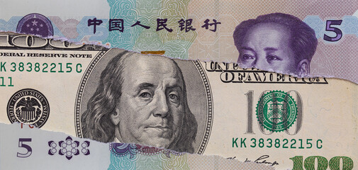 Torn Chinese Five Yuan Banknote Revealing US One Hundred Dollar Bill