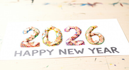 Creative happy new year 2026 text with vibrant pencil shavings art on white background Vector