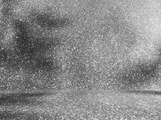 Empty gray glitter room studio with sunlight effect shadow. Minimal background for product presentation. Summer backdrop. Cosmetic and beauty products display room. Glittering light shiny surface.