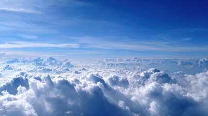 Naklejka premium Bright clouds float high in a clear blue sky during daylight. Sunlight breaks through creating a serene scene that inspires tranquility and wonder.
