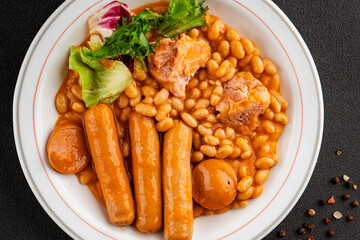 Casule meat with beans in sauce sausages, pork main course tasty snack fresh delicious gourmet food table background rustic food top view copy space