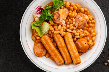 Casule meat with beans in sauce sausages, pork main course tasty snack fresh delicious gourmet food table background rustic food top view copy space