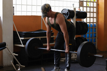 Man training deadlift exercise in gym, building body strength and working on physical fitness...