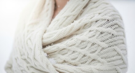 Close-up of white wool shawl draped over shoulders with soft texture  