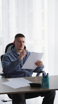 Journalism and paperwork.
A man works in an office and signs important documents.
An editor corrects text on a white sheet of paper.
Calligraphy and handwriting