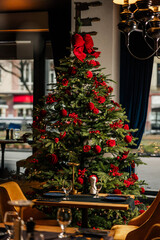 Beautiful Christmas tree decorated with red ornaments
Festive holiday tree adorned with red bows and baubles
Classic Christmas decoration featuring a lush evergreen tree