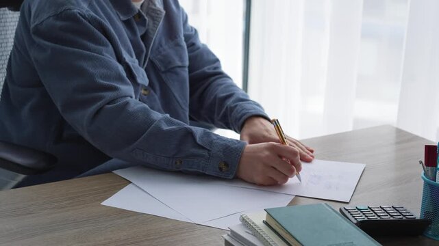 Journalism and paperwork.
A man works in an office and signs important documents.
An editor corrects text on a white sheet of paper.
Calligraphy and handwriting