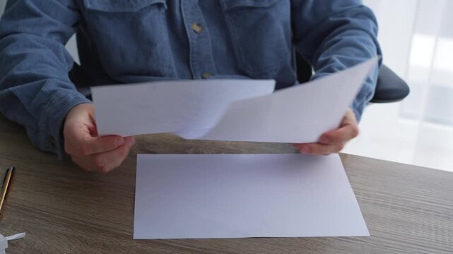 Journalism and paperwork.
A man works in an office and signs important documents.
An editor corrects text on a white sheet of paper.
Calligraphy and handwriting