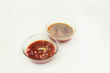 A glass container with spoiled borscht shows advanced mold growth and a discolored surface indicating long-term food spoilage.