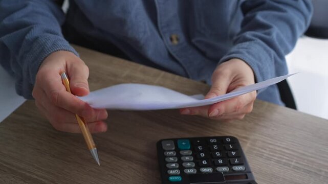 A man sits at a desk, writing something with a pen on a white sheet of paper.
A screenwriter writes a text on a piece of paper.
Education and training, a smart guy writes something with a pen.
Writing