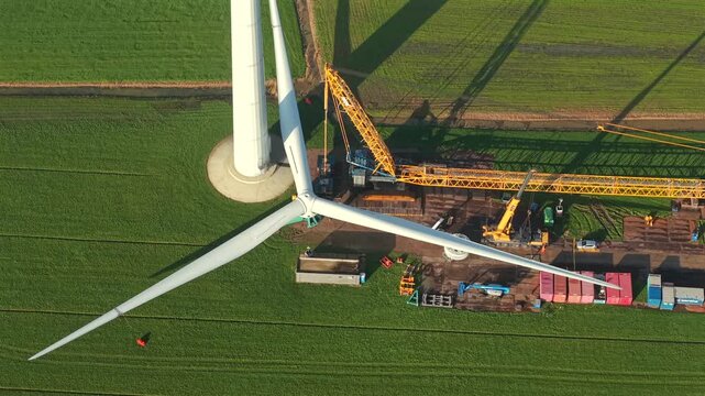 Wind Turbine Construction with Crane Installing Rotor Blades
