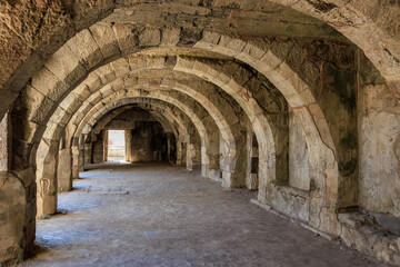 Ancient stone arched corridor in historical roman ruins. Authentic ancient Smyrna ruins in Izmir, Turkey