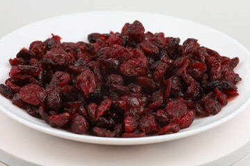 Dried cranberries arranged on a white plate for display