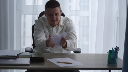 A man sitting at his desk in an office rips up paper documents or a contract.
Nervous breakdown at work due to overwork and depression.
Problems at work.
Needed on weekends.