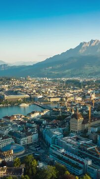 sunny evening flight over luzern city lakeside bay mountains skyline aerial vertical panorama 4k timelapse switzerland