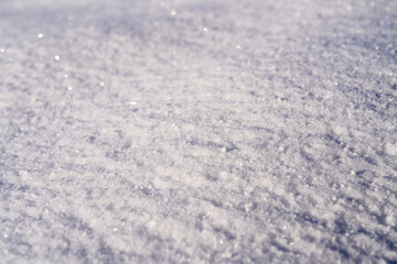 Natural snow texture, winter background with snow patterns, smooth surface of clean fresh snow. Winter background with snow patterns. Closeup top view. Snowy ground. Christmas and New Year design.