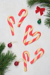 Christmas shortbread cookies and candy canes in Christmas decor on a white concrete background. Merry Christmas.